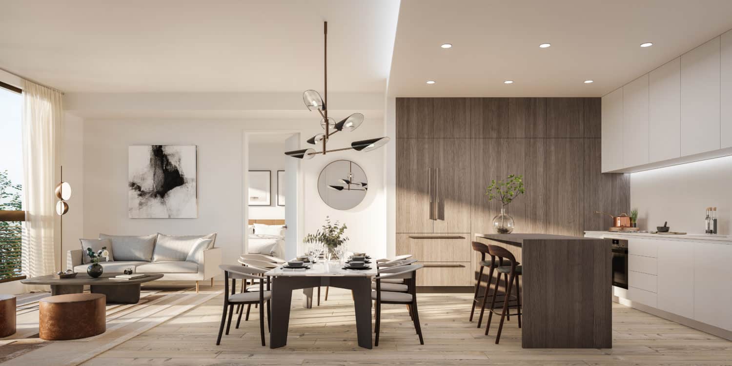 Interior view of The Bristol Condos. Open living space with white kitchen cabinets, long dining room table and living room.