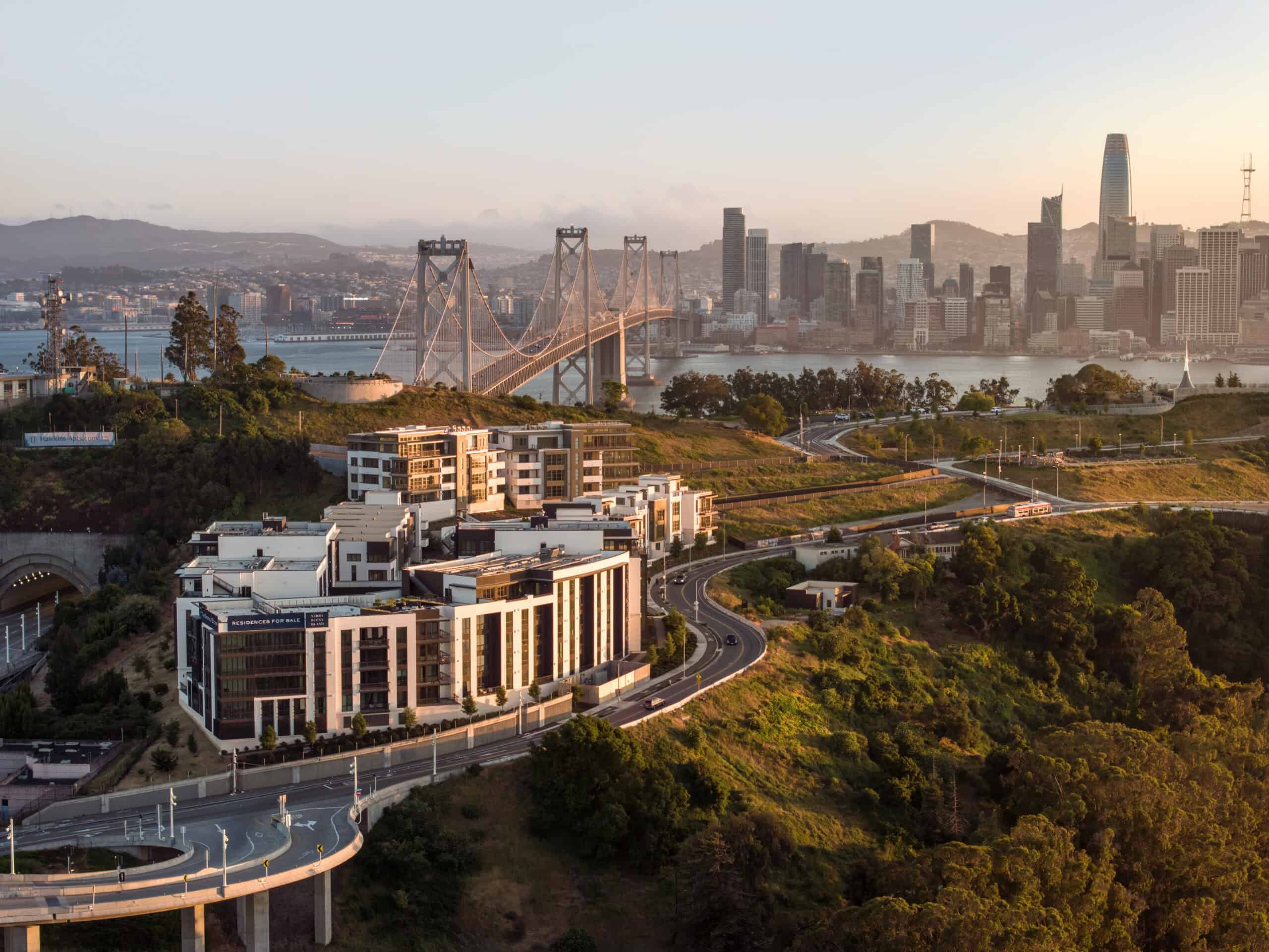 Birdseye view over Yerba Buena Island residences with Downtown San Francisco in the background.